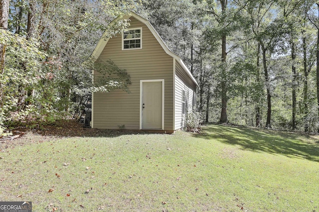 view of outbuilding with a yard