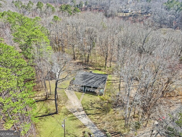 ranch-style home with covered porch, a front lawn, and a shed