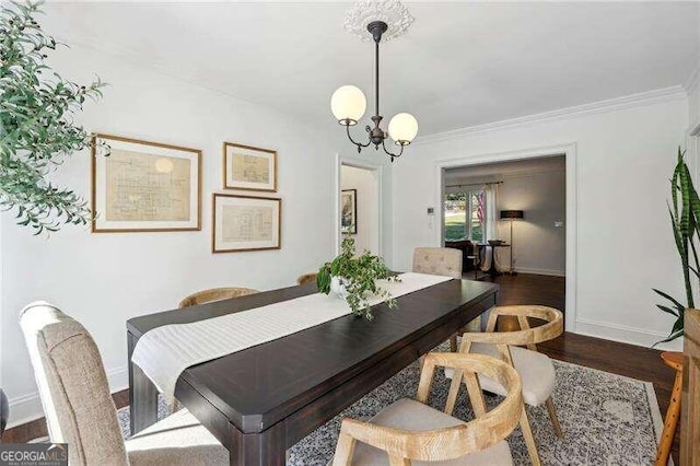 dining area with dark hardwood / wood-style floors, crown molding, and a notable chandelier