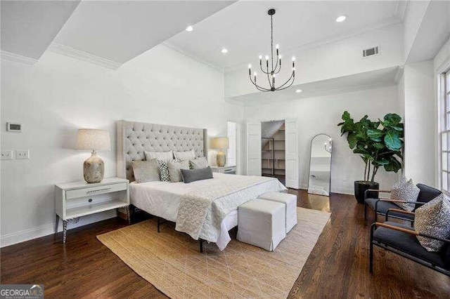 bedroom with hardwood / wood-style floors, a notable chandelier, and ornamental molding