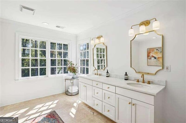 bathroom featuring tile patterned flooring, vanity, and ornamental molding