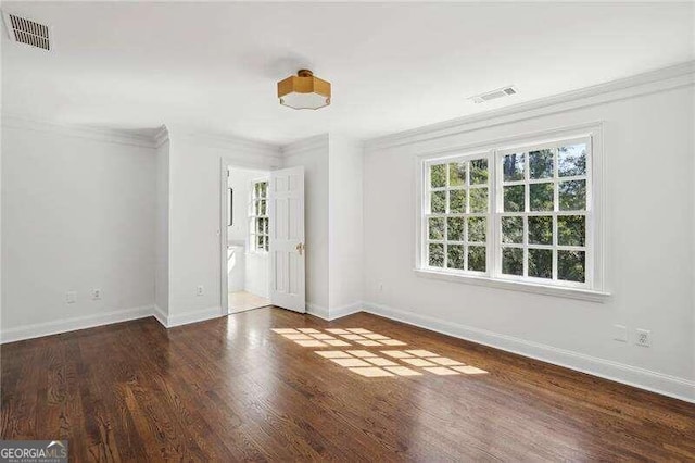 unfurnished room featuring crown molding and dark hardwood / wood-style floors