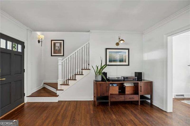 entrance foyer with crown molding and dark hardwood / wood-style flooring