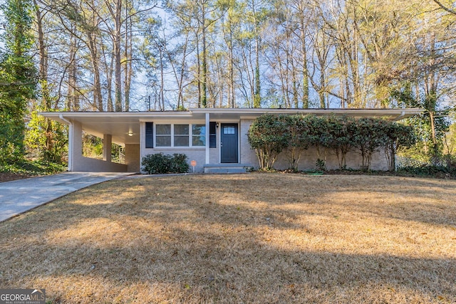 ranch-style home with a carport and a front lawn