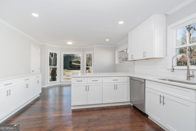 kitchen with dishwasher, white cabinets, sink, tasteful backsplash, and kitchen peninsula