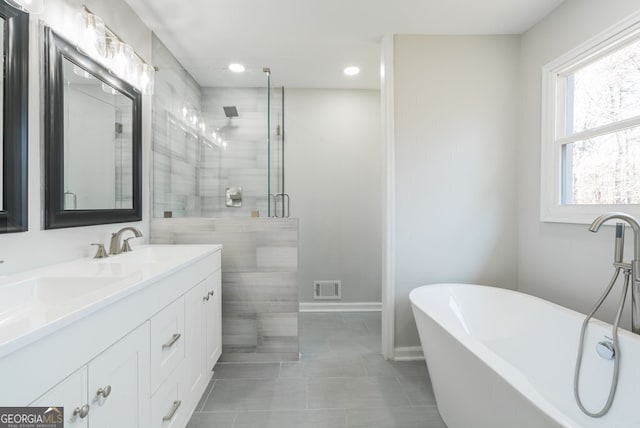 bathroom with tile patterned flooring, vanity, and independent shower and bath