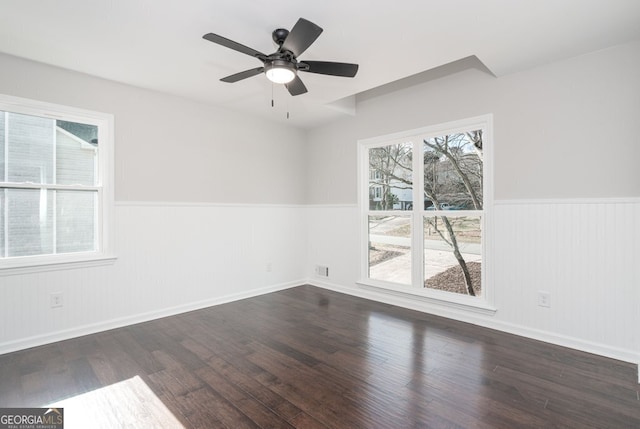 empty room with ceiling fan and dark wood-type flooring