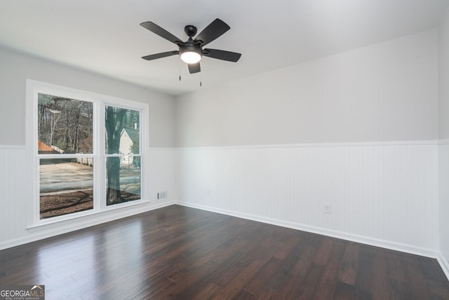 unfurnished room featuring ceiling fan and dark hardwood / wood-style flooring