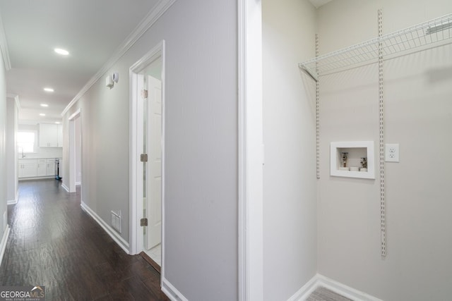 washroom with washer hookup, dark hardwood / wood-style floors, and ornamental molding