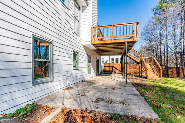 view of property exterior featuring a patio area and a wooden deck