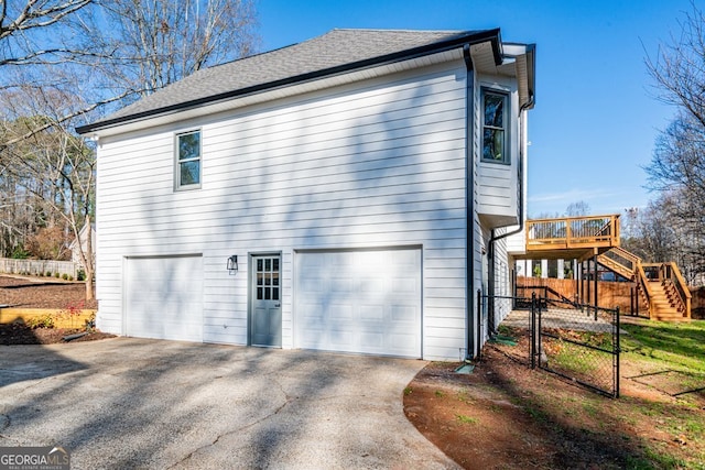 view of property exterior featuring a deck and a garage