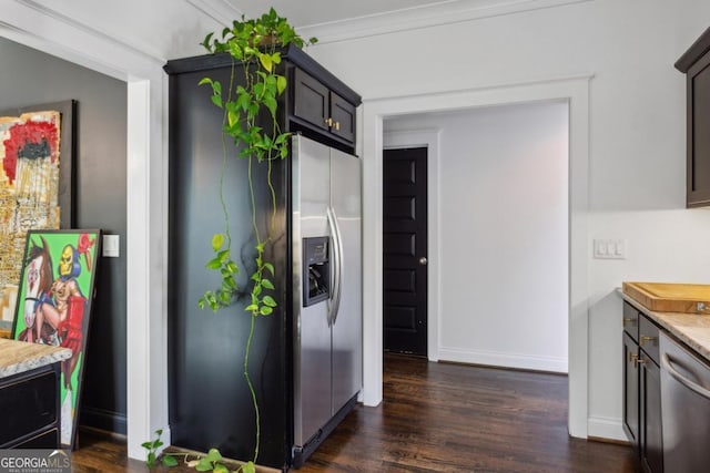 kitchen with crown molding, dark hardwood / wood-style flooring, light stone counters, dark brown cabinetry, and stainless steel appliances