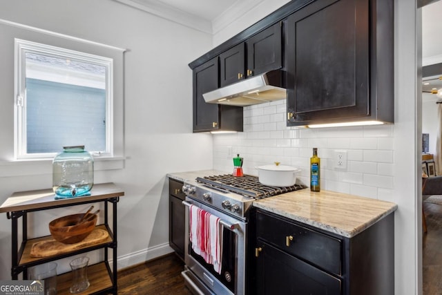 kitchen with light stone countertops, tasteful backsplash, high end stove, crown molding, and dark hardwood / wood-style floors