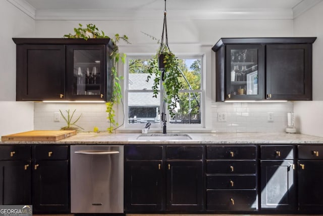 kitchen featuring dishwasher, ornamental molding, sink, and decorative light fixtures