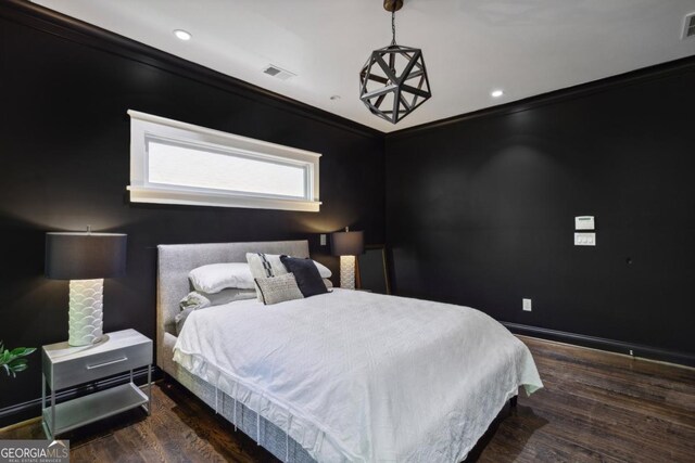 bedroom featuring dark hardwood / wood-style flooring and ornamental molding