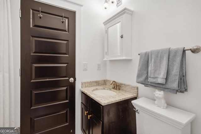 bathroom featuring vanity and toilet