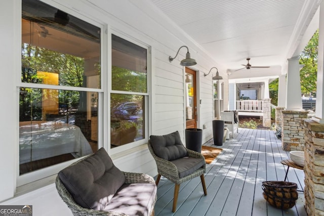 wooden deck featuring ceiling fan and a porch