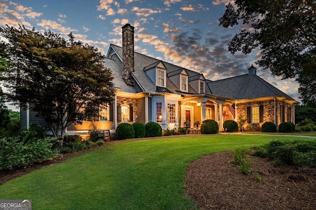 cape cod house with a yard