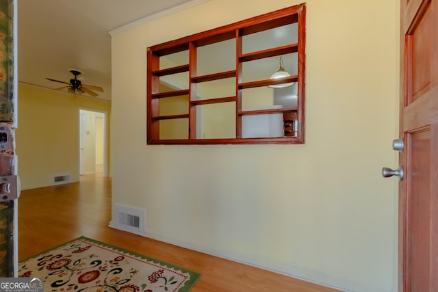 hall featuring light hardwood / wood-style floors and ornamental molding