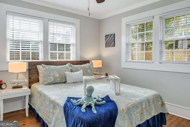 bedroom with hardwood / wood-style flooring and ceiling fan