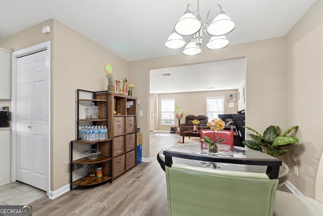 dining room featuring an inviting chandelier and light hardwood / wood-style flooring