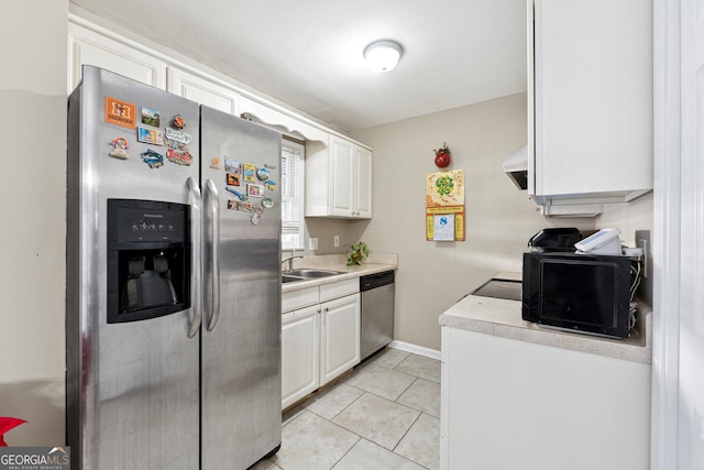 kitchen featuring white cabinets, sink, light tile patterned floors, appliances with stainless steel finishes, and extractor fan