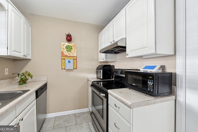 kitchen with light tile patterned flooring, white cabinetry, sink, and appliances with stainless steel finishes