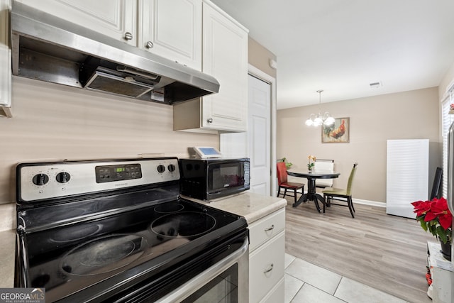 kitchen with black appliances, pendant lighting, an inviting chandelier, white cabinetry, and light tile patterned flooring