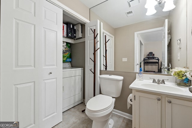 bathroom featuring vanity, an inviting chandelier, tile patterned flooring, washer / clothes dryer, and toilet