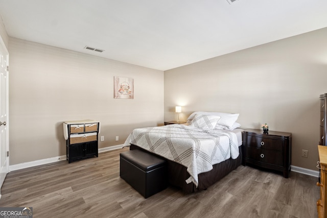 bedroom with wood-type flooring