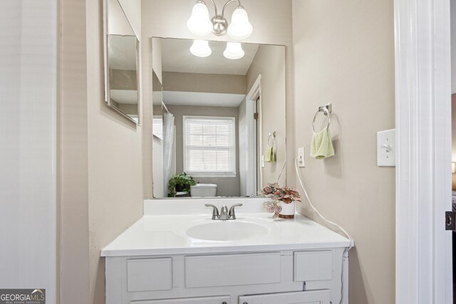 bathroom with vanity and a chandelier