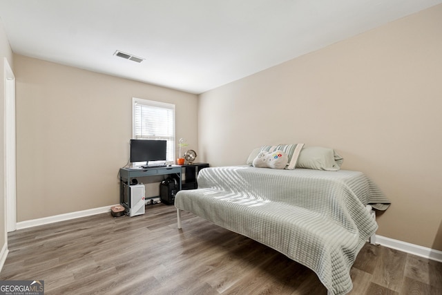 bedroom with hardwood / wood-style flooring