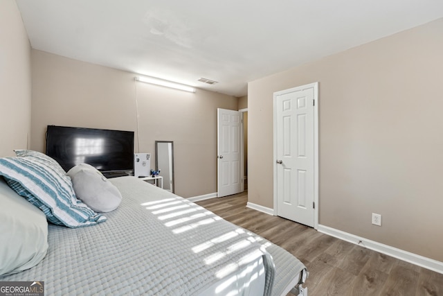 bedroom with hardwood / wood-style flooring