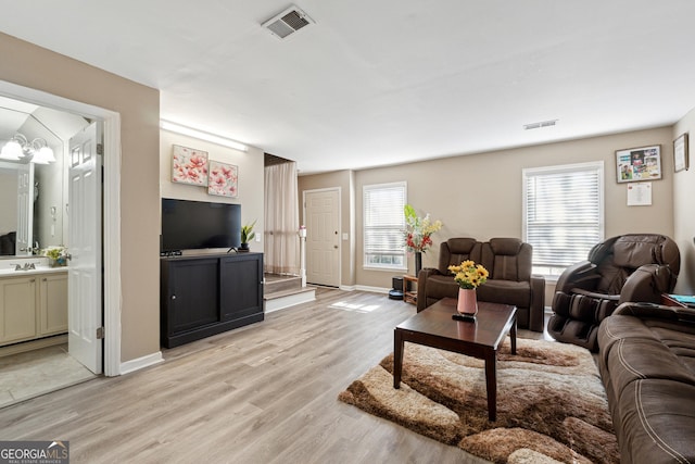 living room featuring light hardwood / wood-style floors and sink