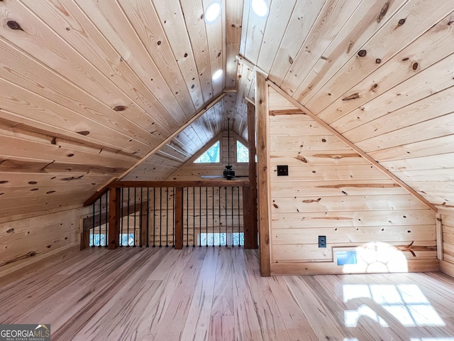 additional living space with lofted ceiling, light hardwood / wood-style flooring, wooden walls, and wood ceiling