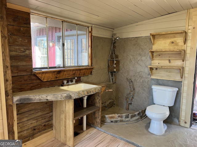 bathroom featuring toilet, wood ceiling, lofted ceiling, and sink