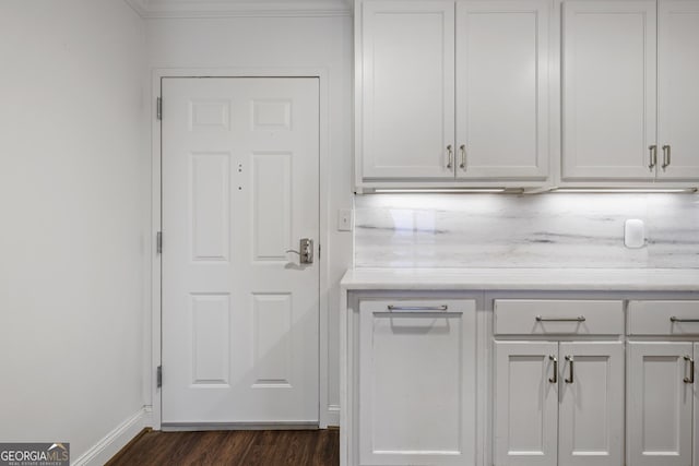 kitchen featuring white cabinetry, light countertops, and dark wood-style flooring