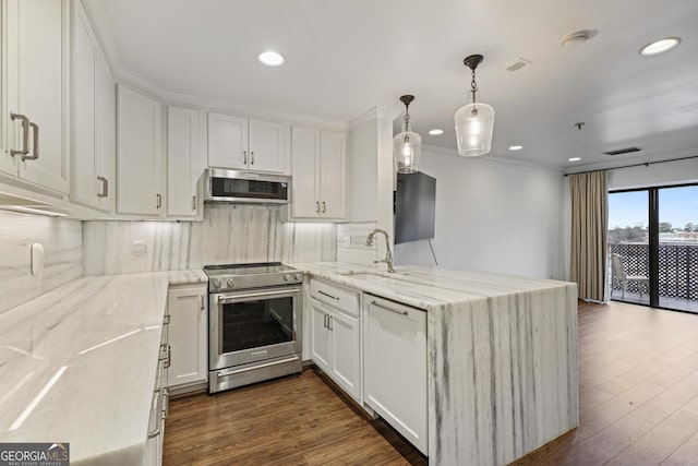 kitchen featuring a peninsula, white cabinets, stainless steel appliances, and a sink