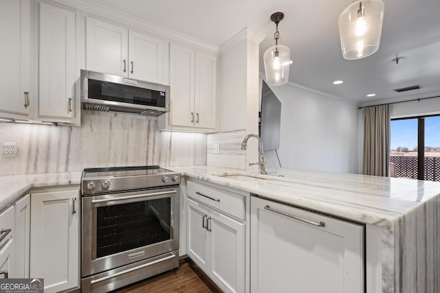 kitchen with stainless steel appliances, decorative backsplash, ornamental molding, a sink, and a peninsula