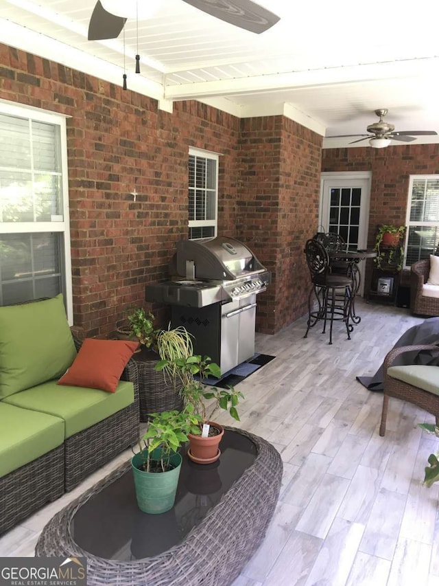 view of patio / terrace featuring ceiling fan, an outdoor hangout area, and grilling area