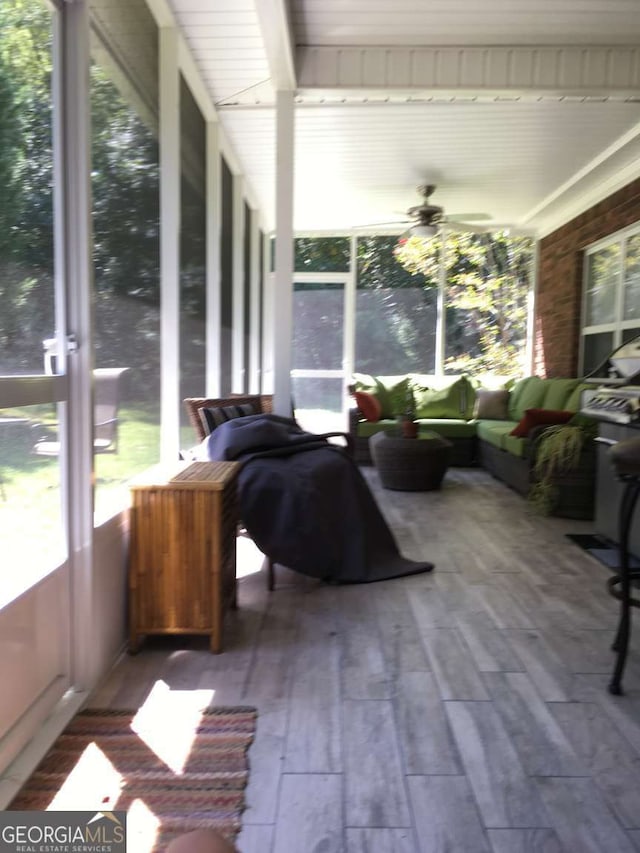 sunroom / solarium featuring ceiling fan