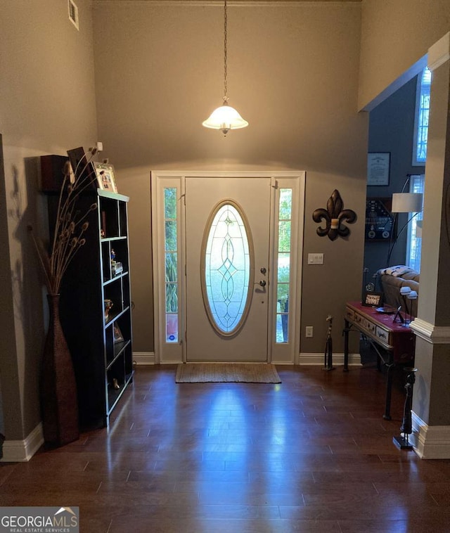 entryway with dark hardwood / wood-style flooring