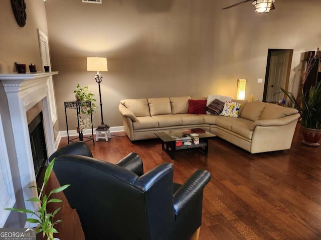 living room featuring dark hardwood / wood-style floors and ceiling fan