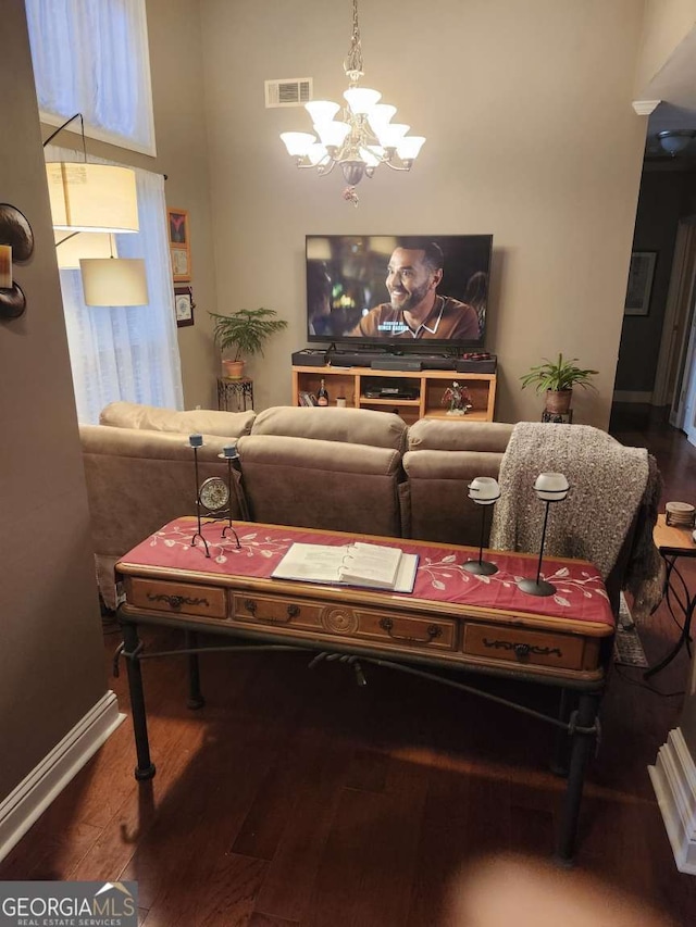 living room with hardwood / wood-style flooring and an inviting chandelier