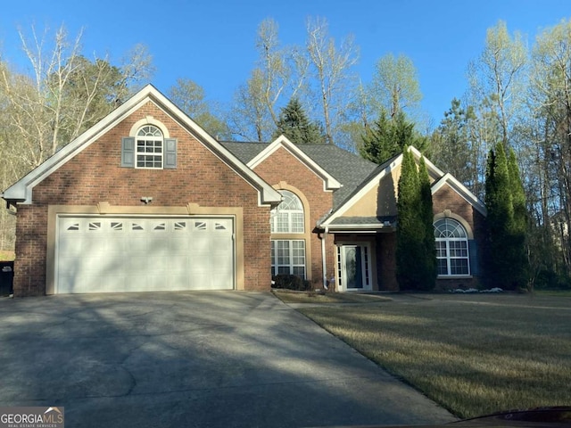 view of front property with a garage and a front yard