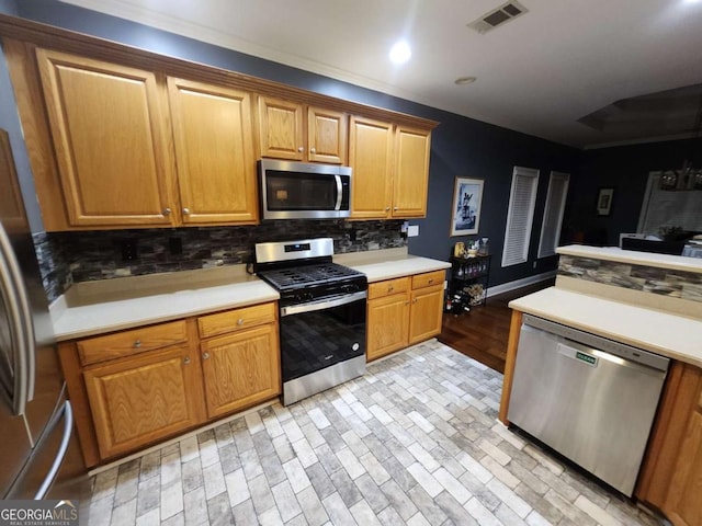 kitchen with decorative backsplash, light wood-type flooring, and stainless steel appliances