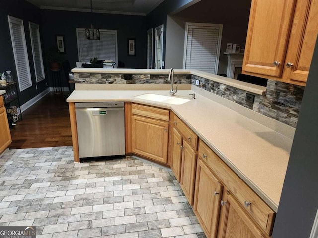 kitchen featuring dishwasher, sink, an inviting chandelier, backsplash, and decorative light fixtures