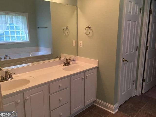 bathroom with a washtub and vanity