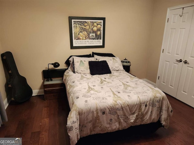 bedroom featuring a closet and dark wood-type flooring