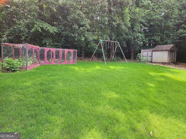 view of yard with a playground and a shed